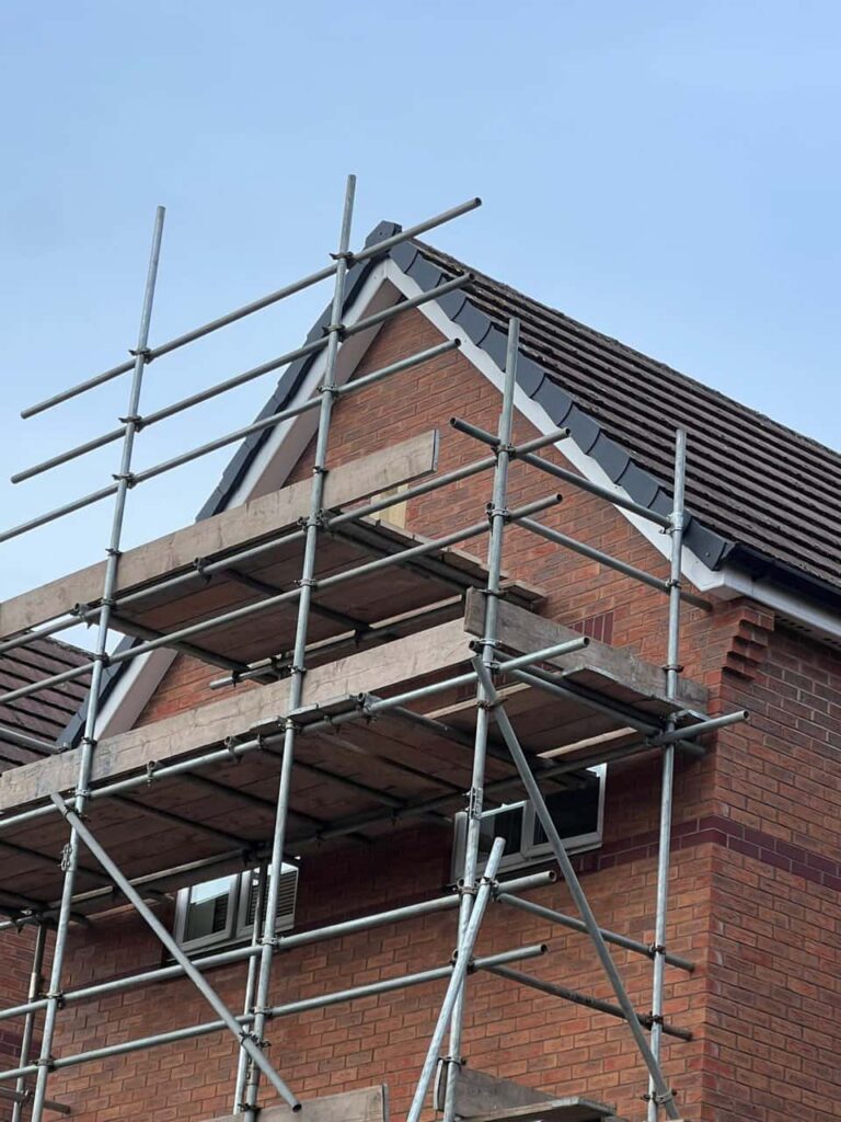 This is a photo of a roof which has just been repaired. There is a scaffold located at the gable end for access onto the roof. Works carried out by Histon Roofing Repairs